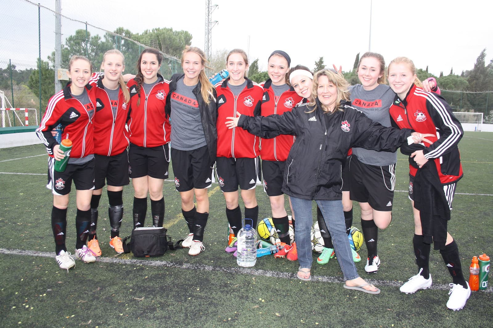Youth girls soccer team happy after match on Spain football tour